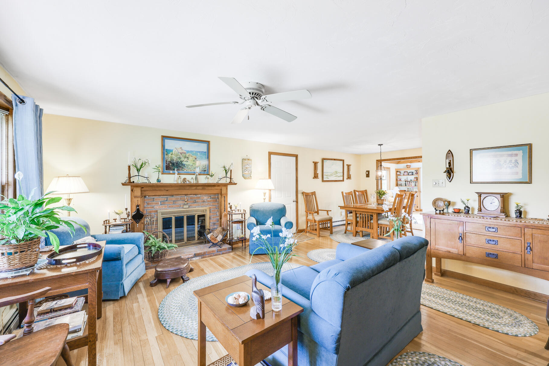 65 Continental Drive Harwich, MA 02645 - Photo 4 of 34 a living room with furniture a fireplace and a potted plant