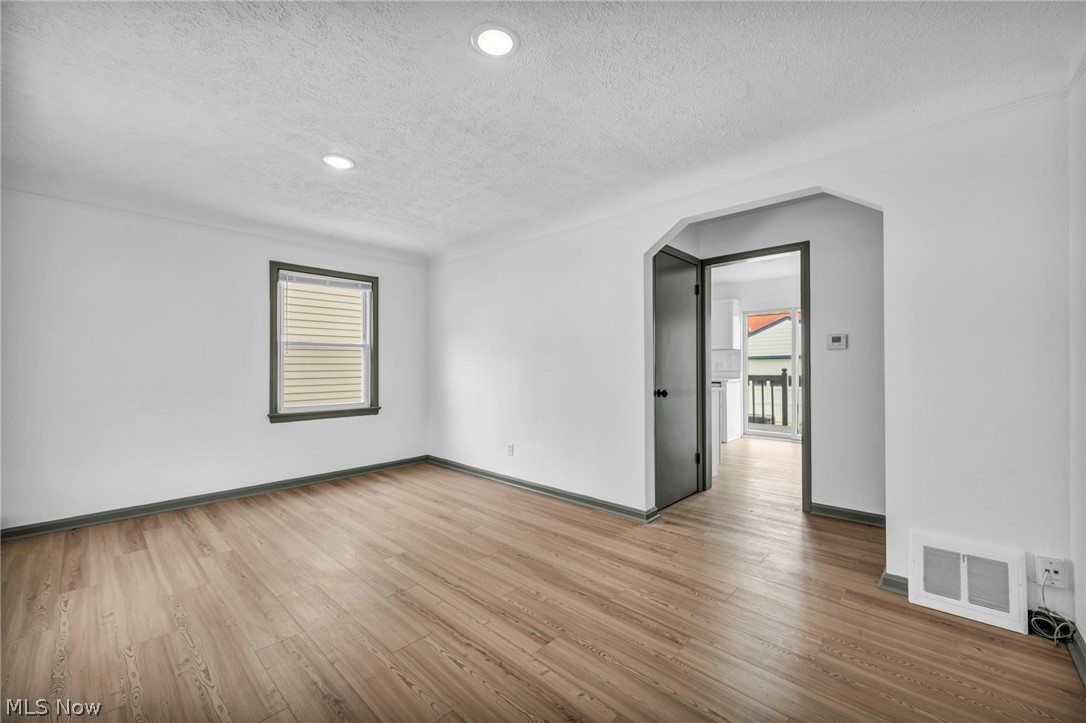 1609 Mapledale Road Wickliffe, OH 44092 - Photo 8 of 46 Spare room with hardwood / wood-style floors and a textured ceiling