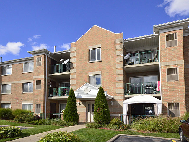 5357 North East River Road, Unit 601 Chicago, IL 60656 - Photo 1 of 1 a front view of a house with a yard