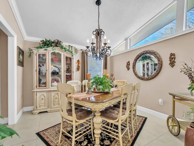 a view of a dining room with furniture and a chandelier