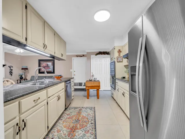 a kitchen with stainless steel appliances a refrigerator and a sink