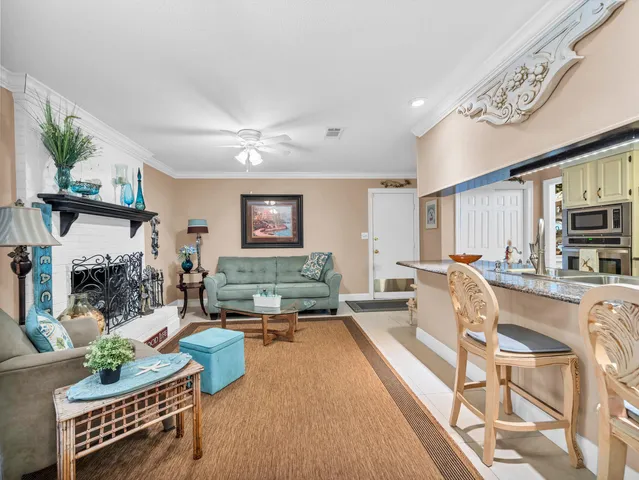 a living room with fireplace furniture and a flat screen tv