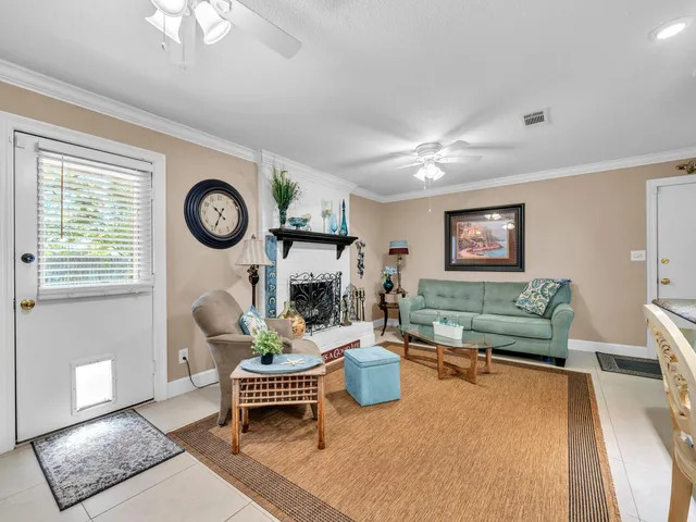 a living room with furniture a clock and a window