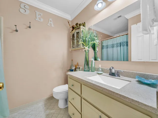 a bathroom with a granite countertop sink a toilet and a mirror