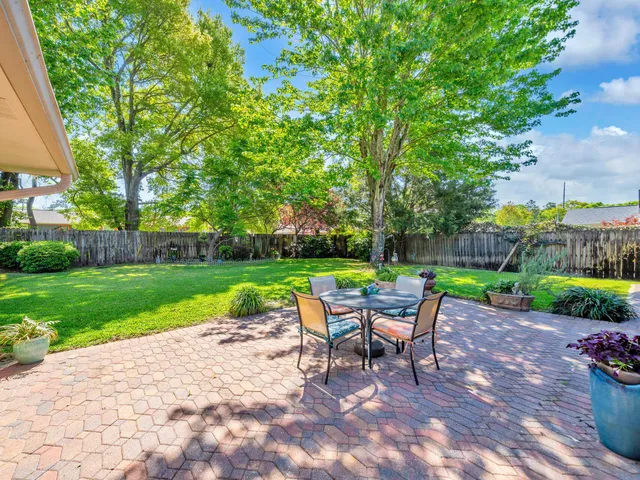 a view of a table and chairs in the garden