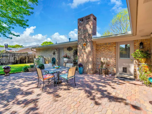 a view of a patio with a table and chairs