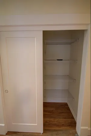 a view of walk in closet with empty racks