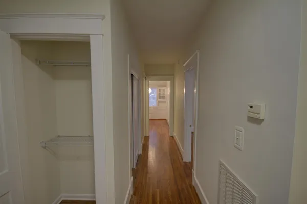 a view of a hallway with wooden floor