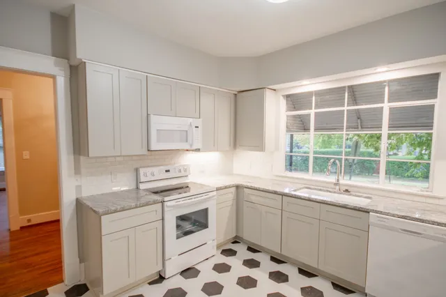 a kitchen with a sink stove and cabinets