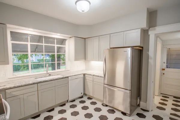 a white refrigerator freezer sitting inside of a kitchen