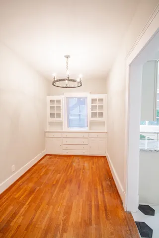 a view of a room with wooden floor and sink