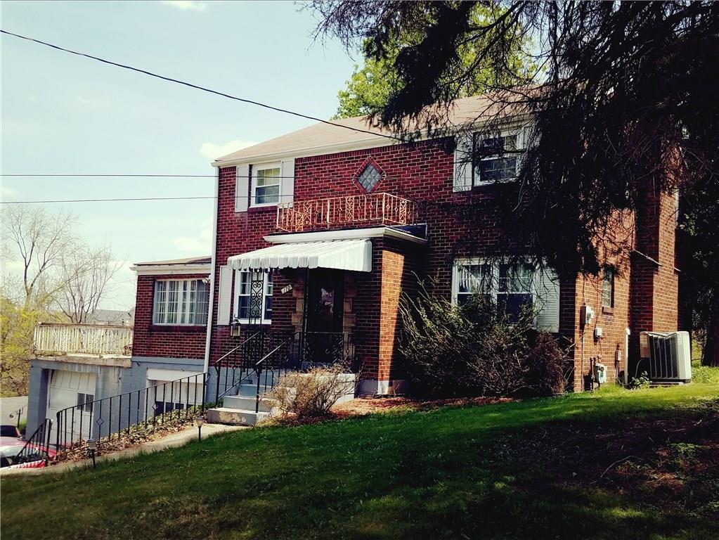 Well built all brick home on large lot with sunroom style family room and adjacent deck over garages.