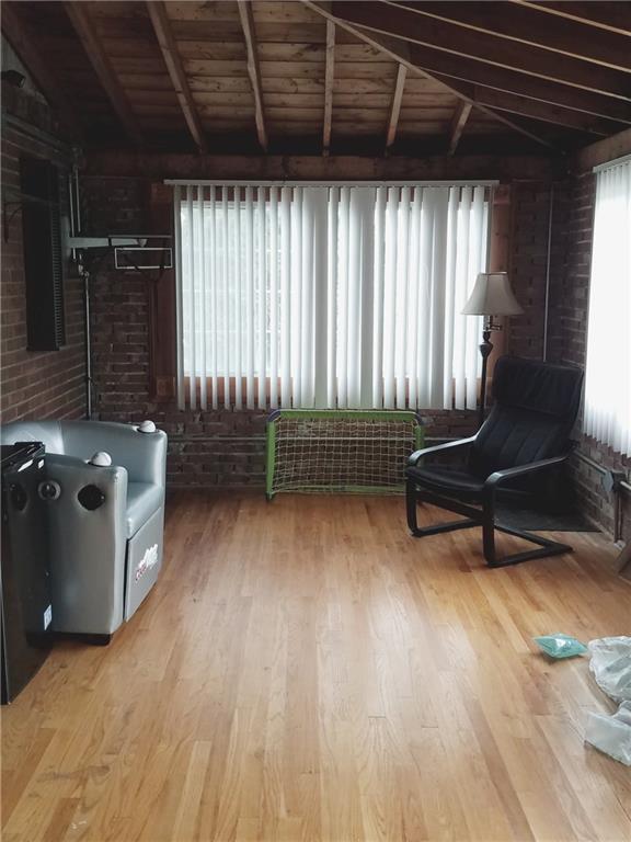 170 Hinkel Road Pittsburgh, PA 15229 - Photo 14 of 25 Family room with hardwood floors and large windows with ceiling open to roof rafters is adjacent to the outside deck and kitchen. It is uninsulated so 3 seasons now but could easily be insulated and heated for year round use.