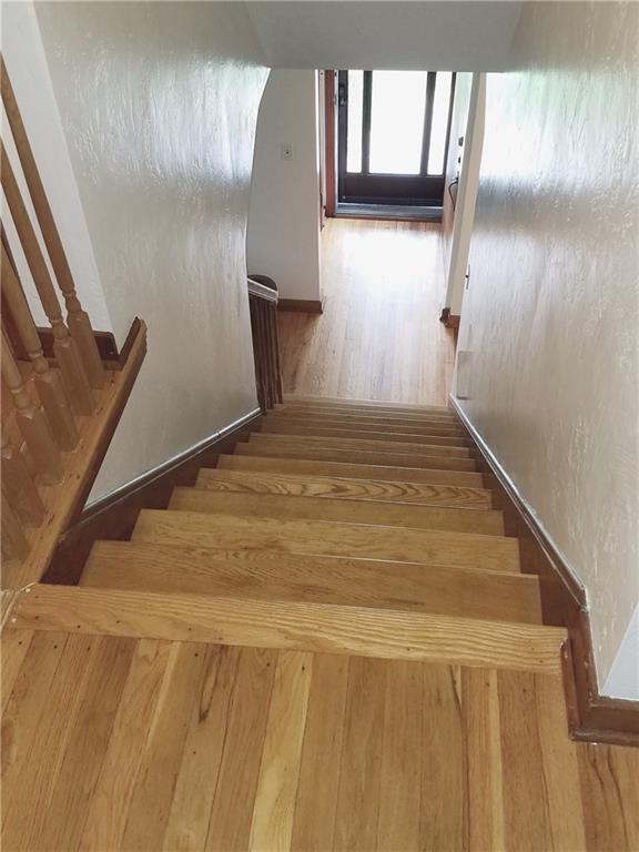 Beautiful hardwood staircase leading to main entry with two guest closets.