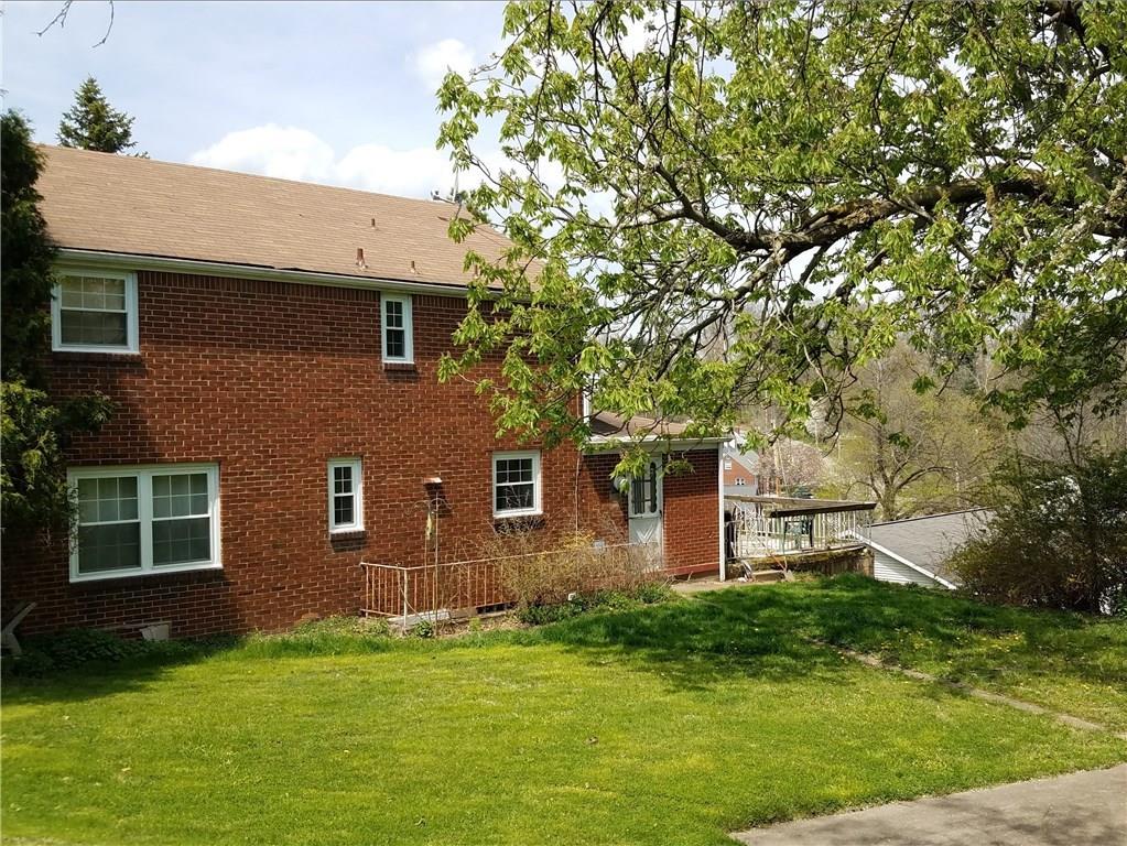 170 Hinkel Road Pittsburgh, PA 15229 - Photo 8 of 25 Rear of this all brick home showing outside stair access to basement and side deck beyond.