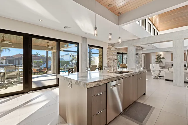 a large white kitchen with a large window