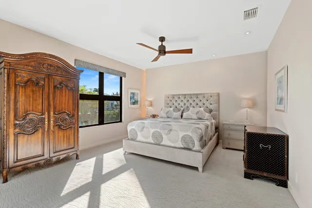 a bedroom with a bed and large window