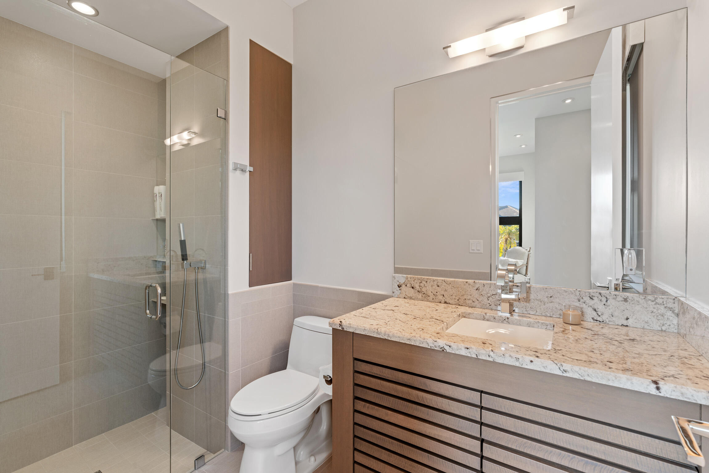 821 Magnolia Court Marco Island, FL 34145 - Photo 24 of 53 a bathroom with a granite countertop toilet a sink and a mirror
