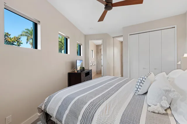 a bedroom with a bed and a painting on the wall