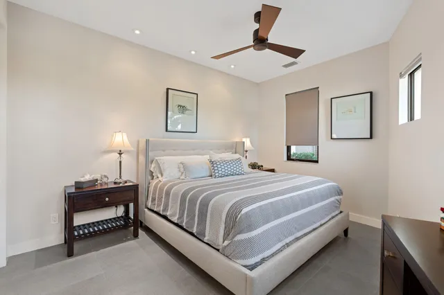 a bedroom with a bed and a lamp