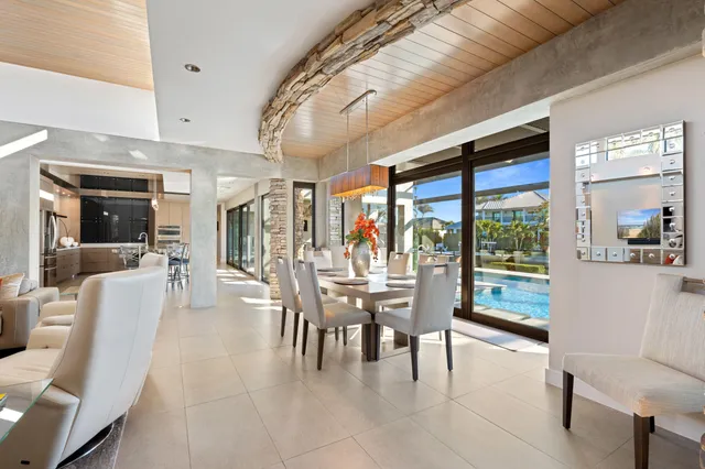a dining area with furniture and a large window
