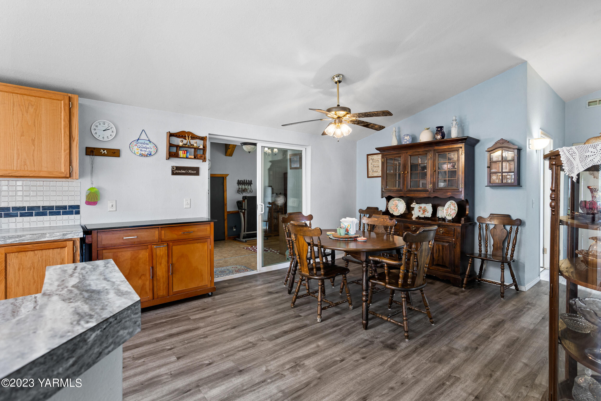 910 Robinson Road Grandview, WA 98930 - Photo 15 of 37 a view of a dining room with furniture and wooden floor