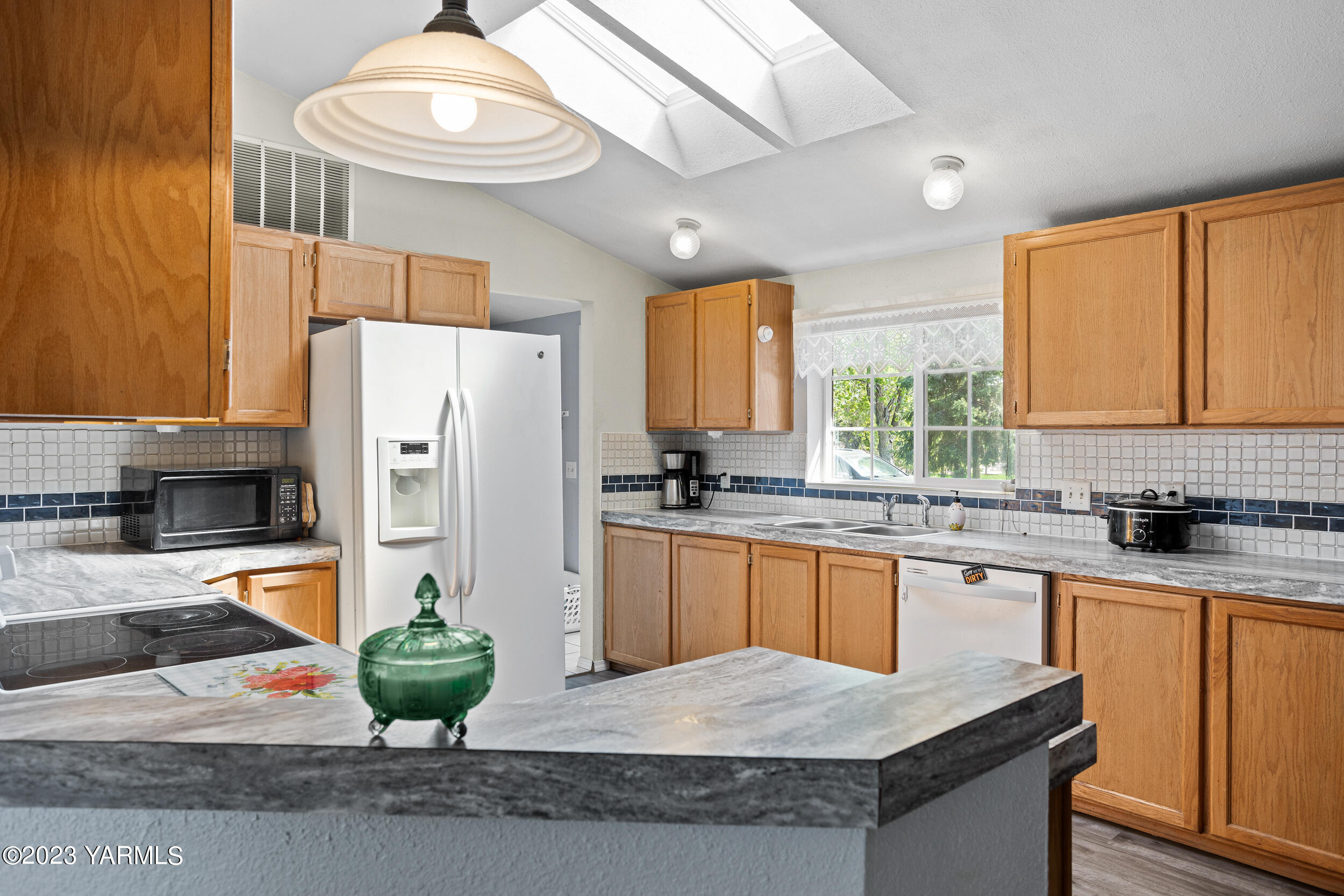 910 Robinson Road Grandview, WA 98930 - Photo 9 of 37 a kitchen with stainless steel appliances granite countertop a sink a stove and a refrigerator