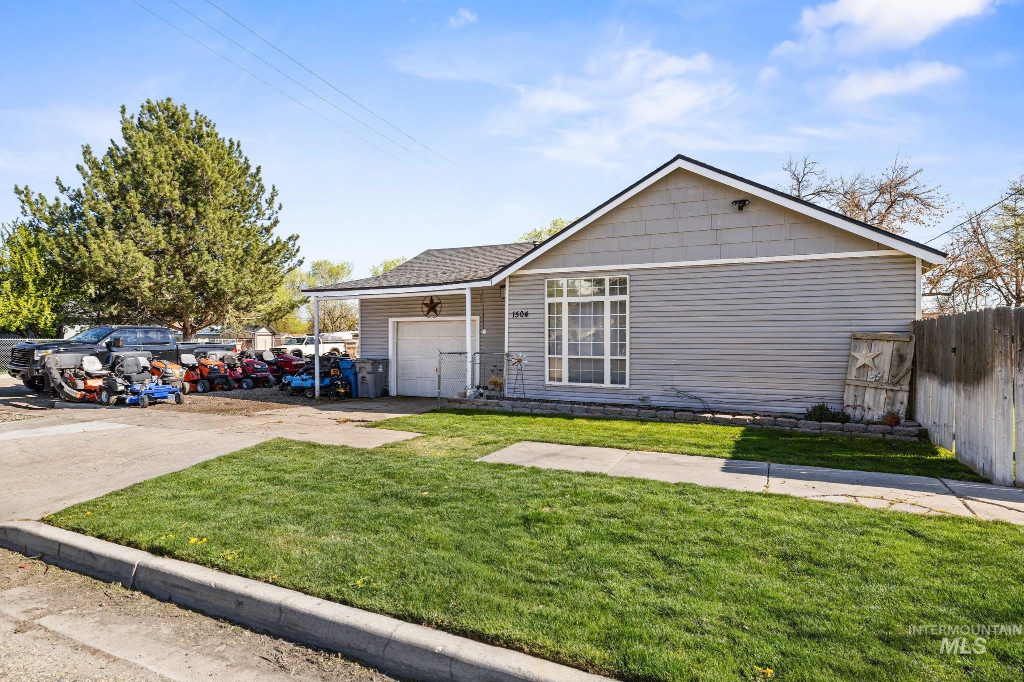 1504 2nd Street North Nampa, ID 83687 - Photo 2 of 29 Ranch-style home with a garage, driveway, and a shingled roof