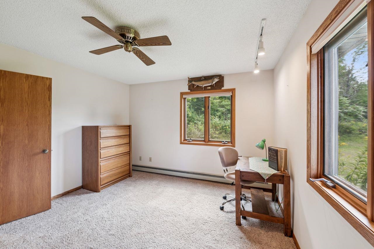 75920 Ondossagon Road Washburn, WI 54891 - Photo 12 of 29 Office area with light colored carpet, a textured ceiling, rail lighting, and ceiling fan