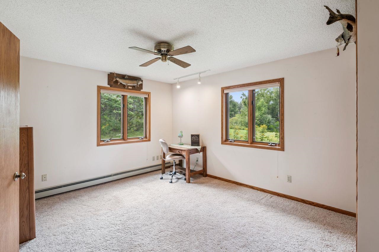 75920 Ondossagon Road Washburn, WI 54891 - Photo 13 of 29 Office area featuring track lighting, plenty of natural light, carpet flooring, baseboard heating, and a textured ceiling