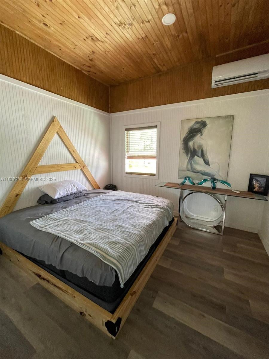 0 Main Grade Road Frostproof, FL 33843 - Photo 5 of 23 a bedroom with a bed and wooden floor