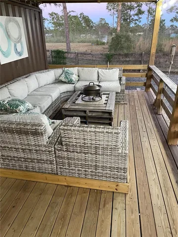 a view of a balcony with couch and wooden floor