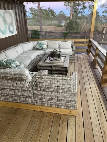 a view of a balcony with couch and wooden floor