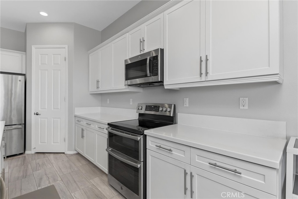 1545 Rio Grande Beaumont, CA 92223 - Photo 11 of 34 a kitchen with white cabinets and stainless steel appliances