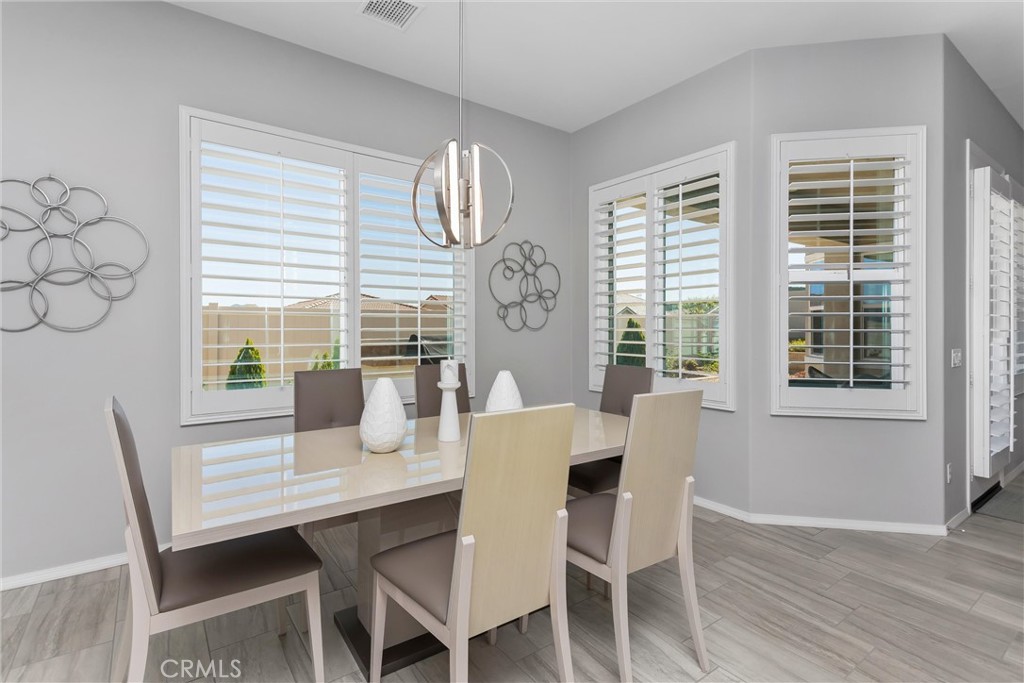 1545 Rio Grande Beaumont, CA 92223 - Photo 13 of 34 a dining room with furniture a rug and wooden floor