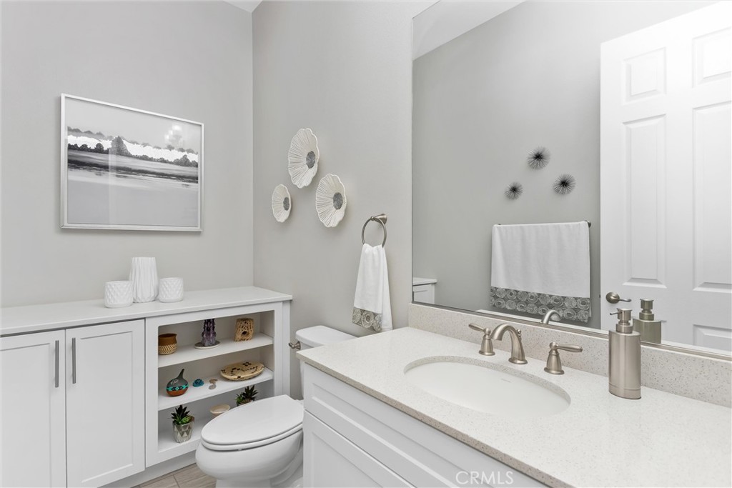 1545 Rio Grande Beaumont, CA 92223 - Photo 20 of 34 a bathroom with a toilet sink vanity granite and mirror