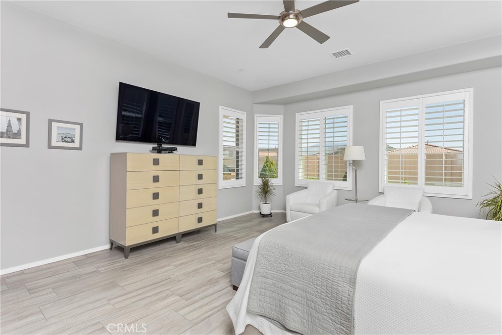 1545 Rio Grande Beaumont, CA 92223 - Photo 23 of 34 a spacious bedroom with a bed and a flat screen tv