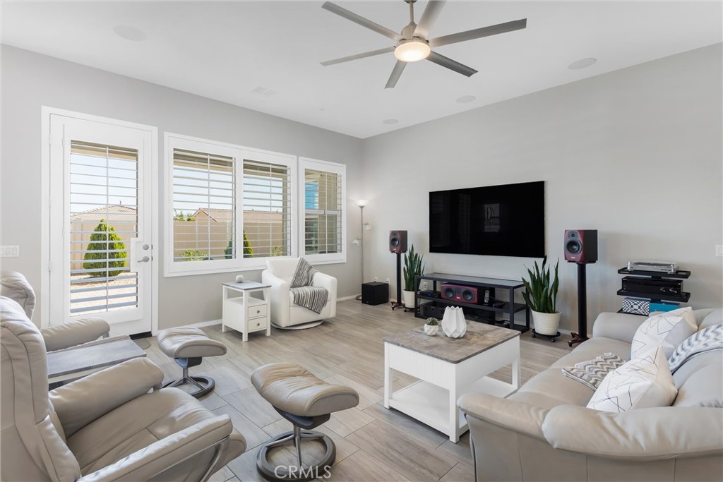 1545 Rio Grande Beaumont, CA 92223 - Photo 5 of 34 a living room with furniture floor to ceiling window and a flat screen tv