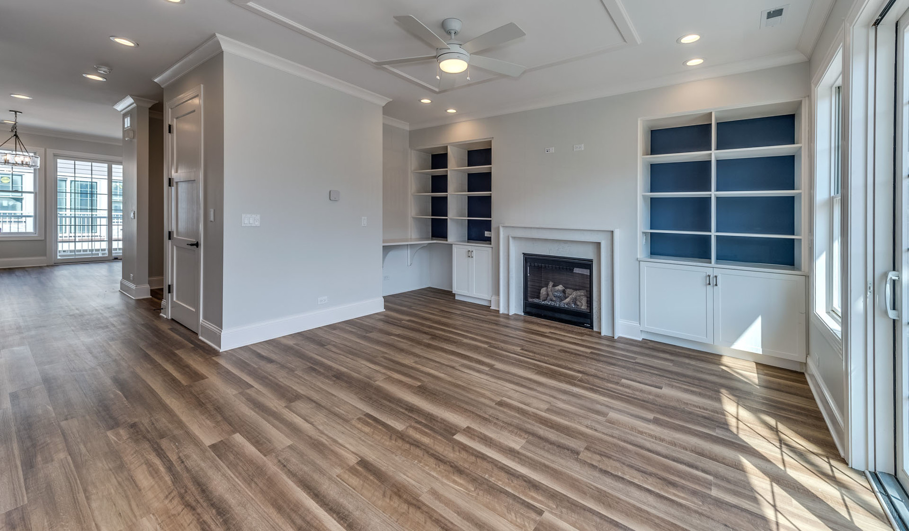 1171 South Eldridge Lane Elmhurst, IL 60126 - Photo 6 of 18 a view of an empty room with wooden floor fireplace and a window