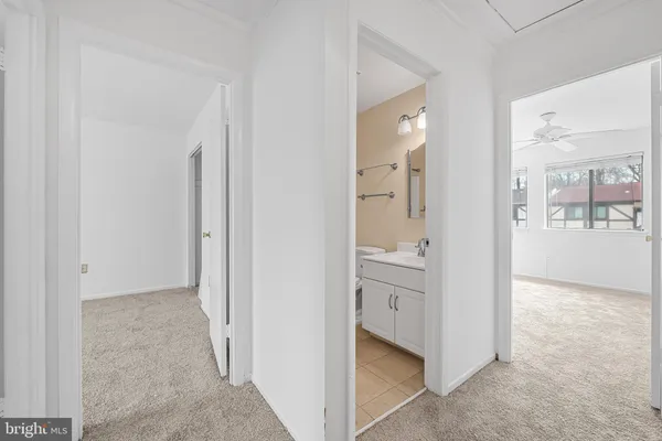 a view of an empty room with window and cabinet