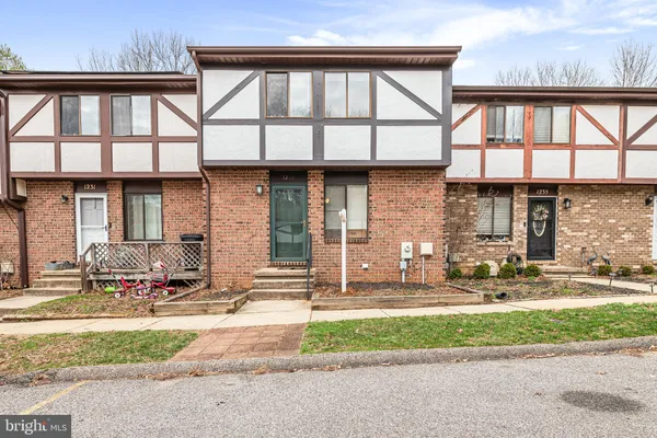 a front view of a house with a garden and plants