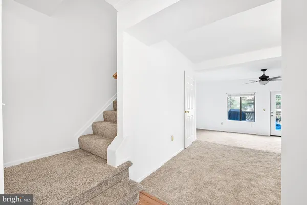 a view of a bedroom with wooden floor and windows