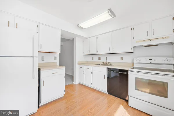 a kitchen with a stove sink and refrigerator