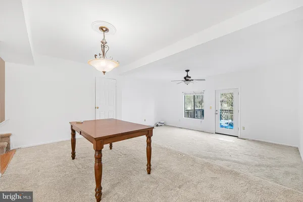 a view of a livingroom with a chandelier furniture and windows