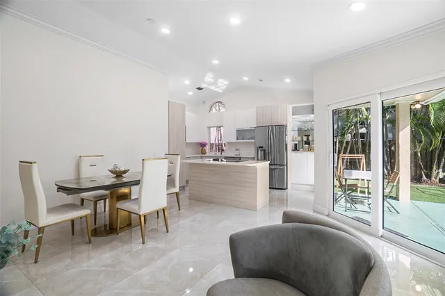 a living room with furniture and a dining table with kitchen view