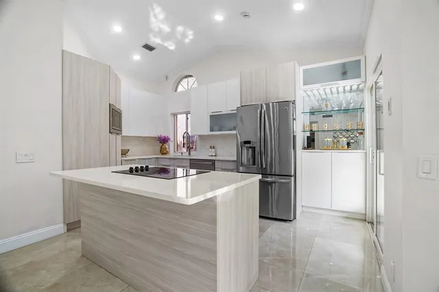 a kitchen with a refrigerator a stove a sink and a refrigerator