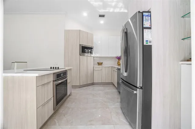 a kitchen with a refrigerator sink and stove