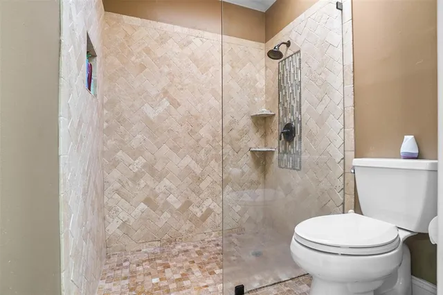 a bathroom with a toilet and a shower