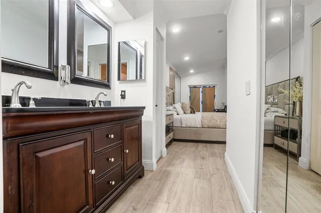 a en suite bathroom with a sink a mirror and a bathtub