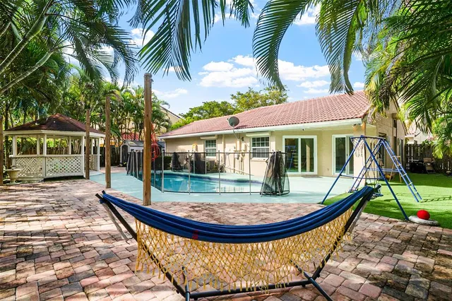 a view of a house with swimming pool and sitting area
